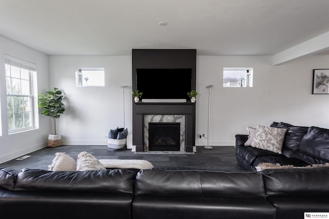 living room with a fireplace and dark hardwood / wood-style flooring