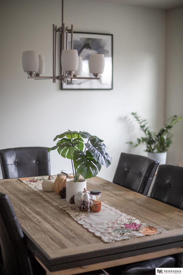 dining space featuring a notable chandelier