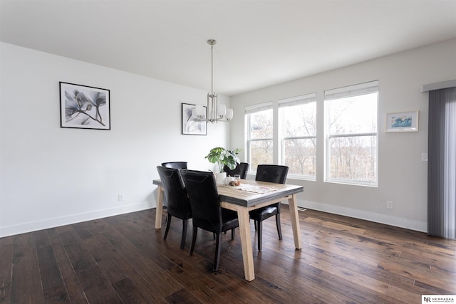 dining space featuring a chandelier and dark hardwood / wood-style floors