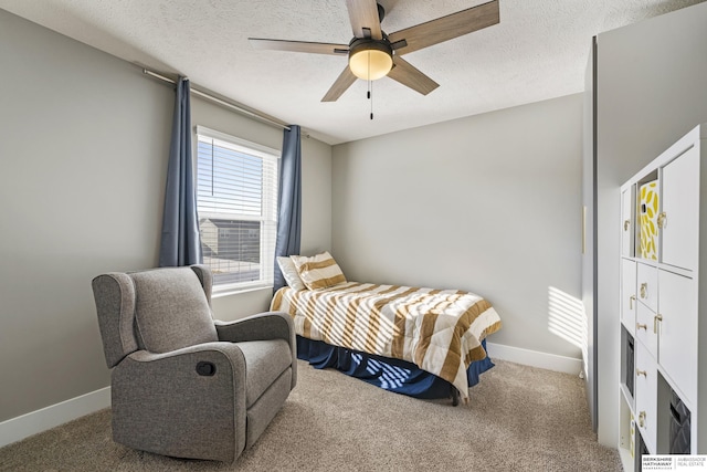 bedroom with carpet flooring, a textured ceiling, and ceiling fan