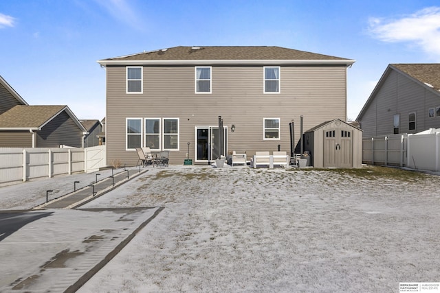 rear view of property featuring a shed