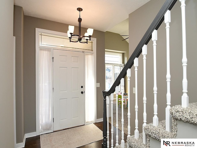 foyer featuring a chandelier and dark hardwood / wood-style floors