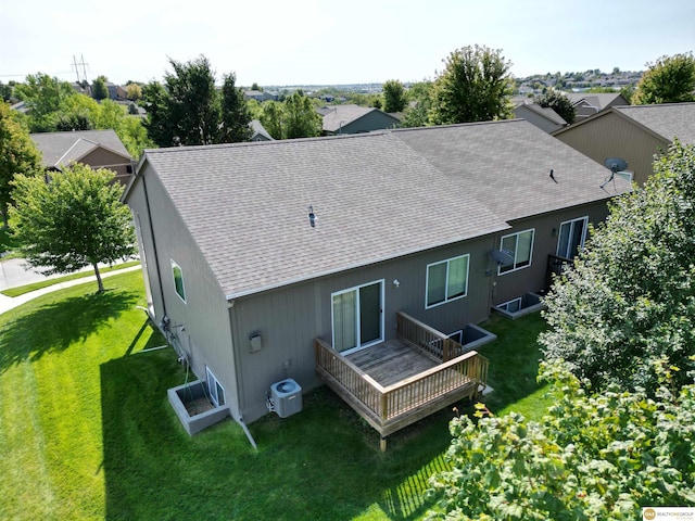 rear view of property with a lawn, cooling unit, and a deck