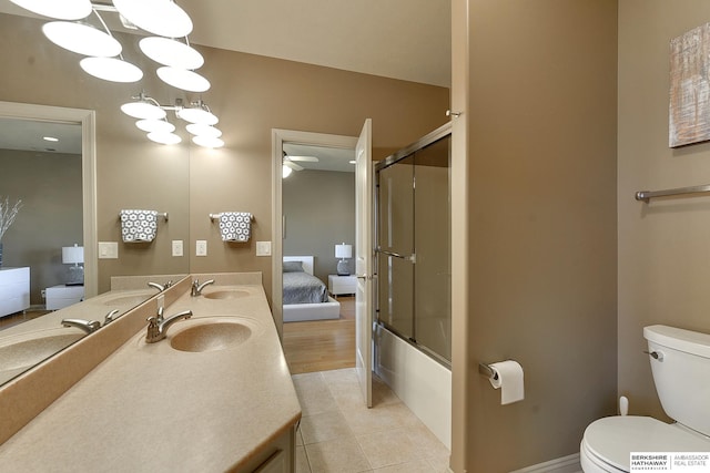 full bathroom featuring ceiling fan, tile patterned flooring, enclosed tub / shower combo, toilet, and vanity