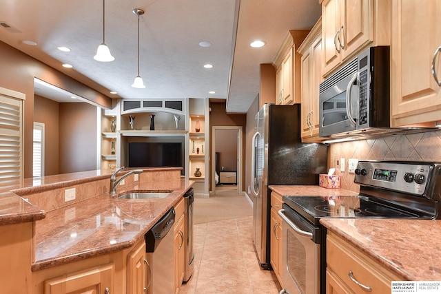 kitchen featuring light stone counters, light brown cabinets, decorative light fixtures, and appliances with stainless steel finishes