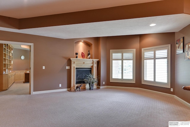 unfurnished living room featuring light carpet