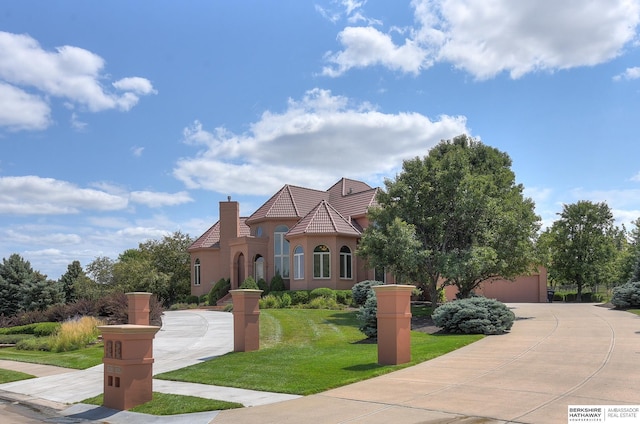 mediterranean / spanish-style home with a front lawn