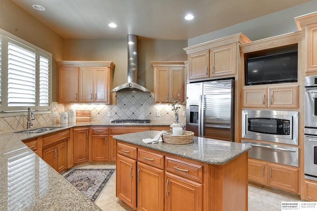 kitchen featuring sink, wall chimney exhaust hood, light tile patterned floors, light stone countertops, and appliances with stainless steel finishes