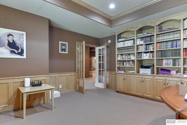 sitting room featuring french doors, light colored carpet, and crown molding