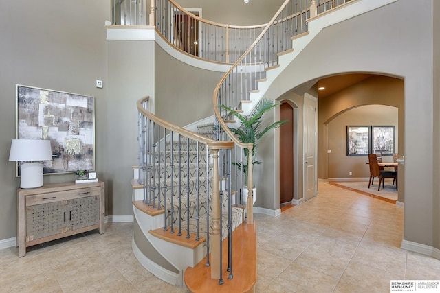 stairs featuring a high ceiling