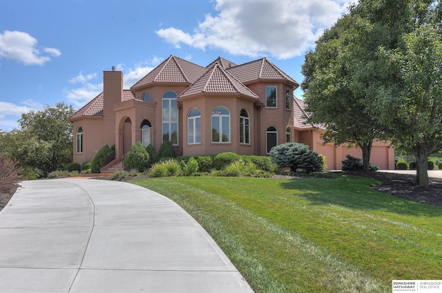 mediterranean / spanish-style house featuring a front yard