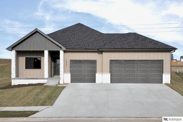 view of front of property with a front lawn and a garage