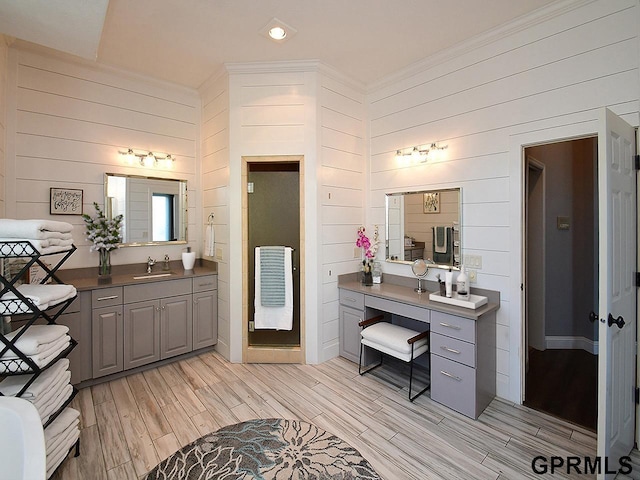 bathroom with vanity and wooden walls