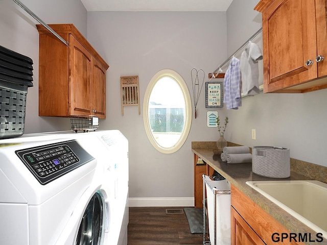 washroom with cabinets, dark hardwood / wood-style flooring, separate washer and dryer, and sink