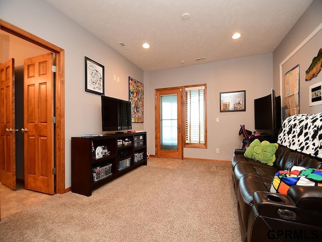 living room with light colored carpet and a textured ceiling