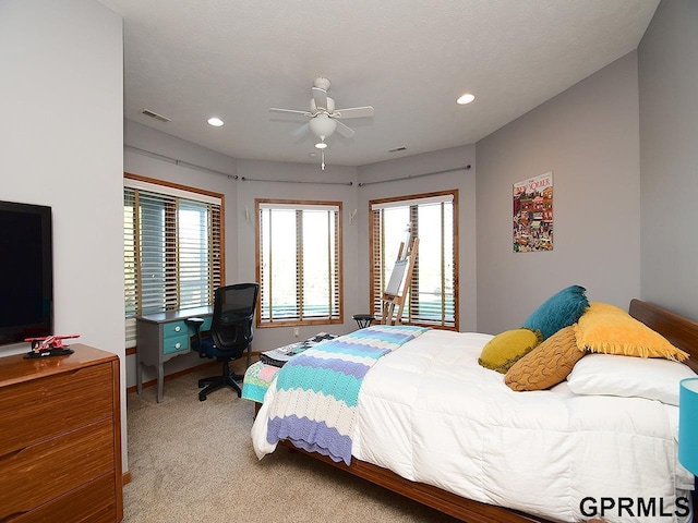 bedroom featuring ceiling fan and light carpet