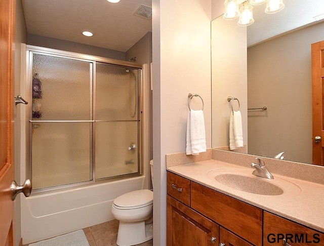 full bathroom with tile patterned flooring, vanity, toilet, and shower / bath combination with glass door