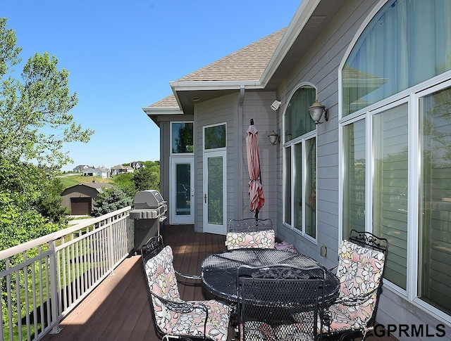 wooden terrace featuring area for grilling