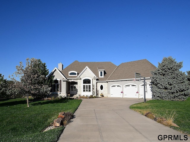 french provincial home with a garage and a front lawn