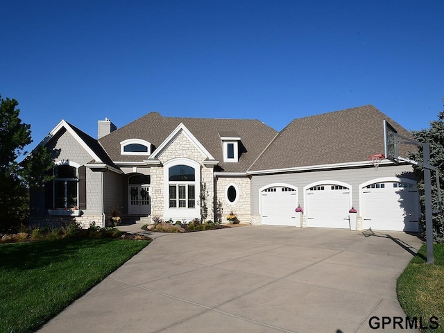 view of front of house with a front yard and a garage