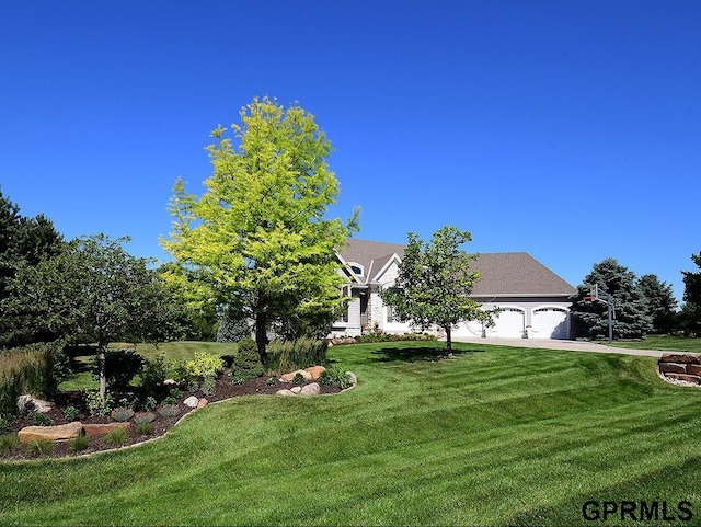 view of front of house with a front yard and a garage