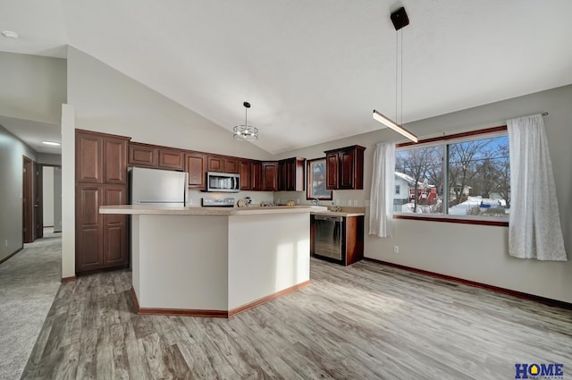 kitchen with appliances with stainless steel finishes, hanging light fixtures, light hardwood / wood-style flooring, and a center island