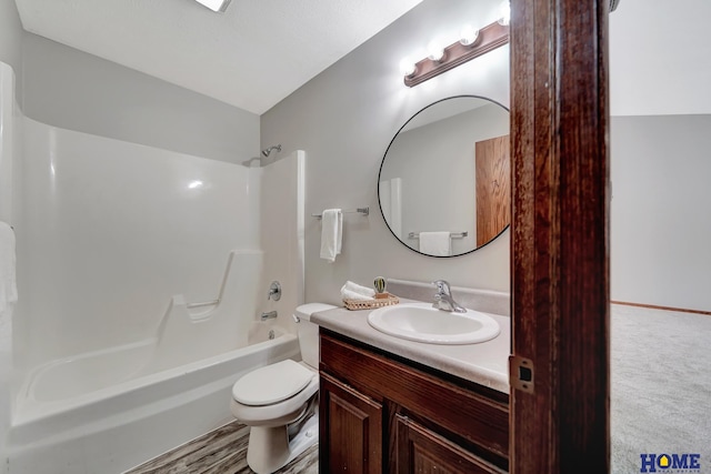 full bathroom featuring bathtub / shower combination, vanity, and toilet