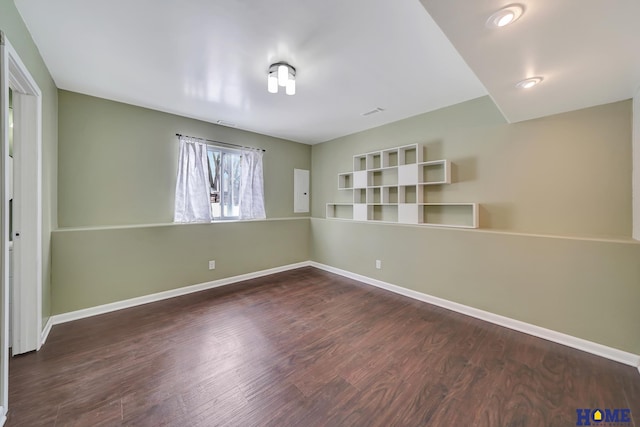 spare room featuring dark wood-type flooring