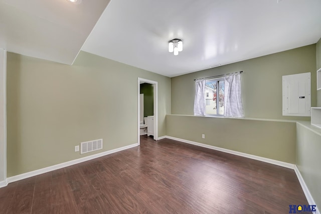 spare room with dark wood-type flooring