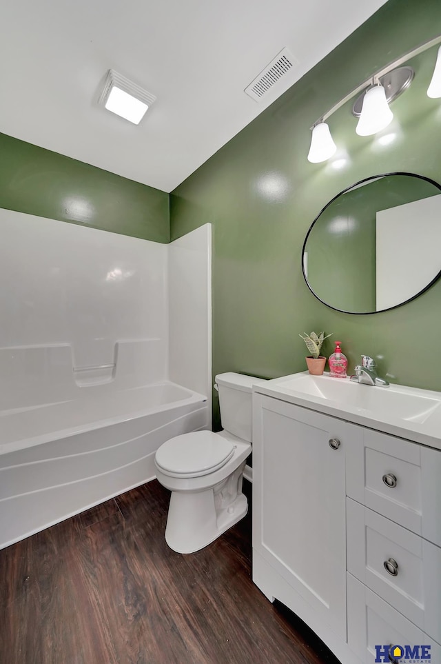 full bathroom with shower / tub combination, toilet, vanity, and wood-type flooring