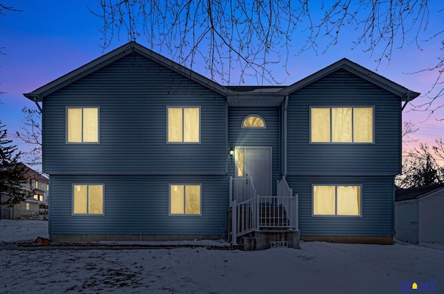 view of back house at dusk