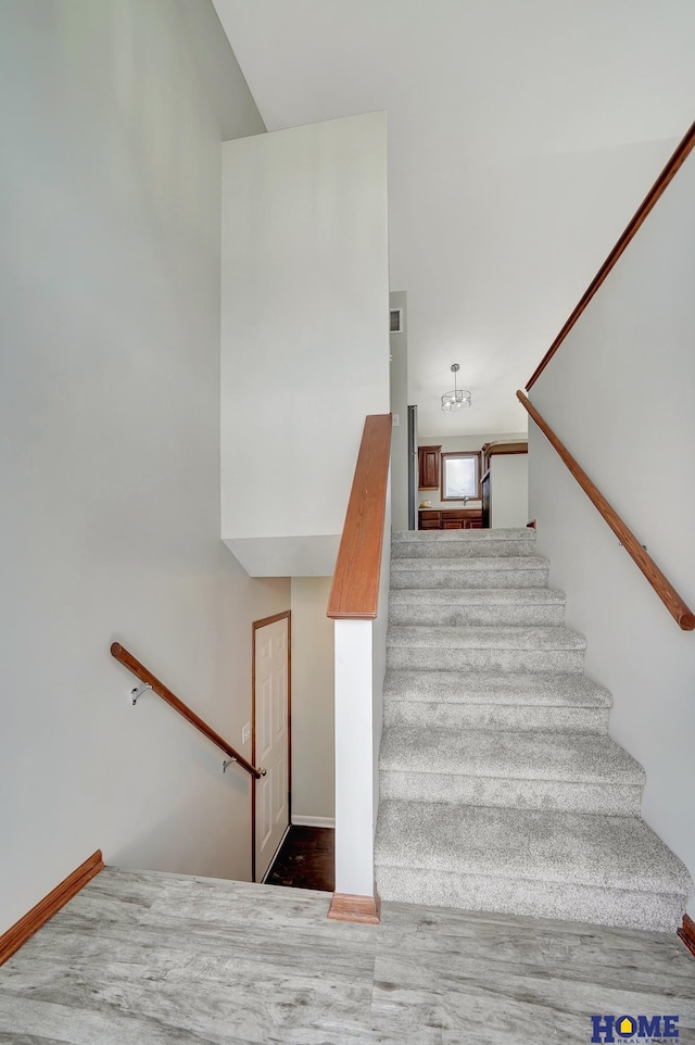 stairway featuring hardwood / wood-style floors