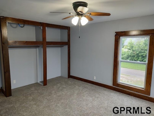 unfurnished bedroom featuring ceiling fan and carpet floors