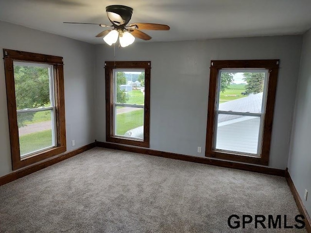 unfurnished room featuring carpet flooring and ceiling fan