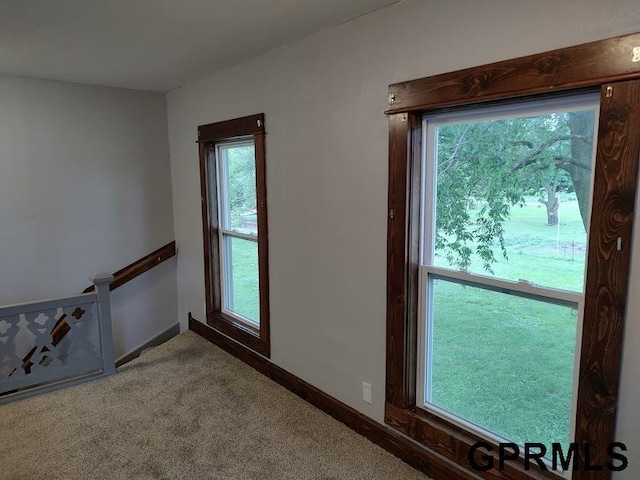 doorway to outside with carpet floors