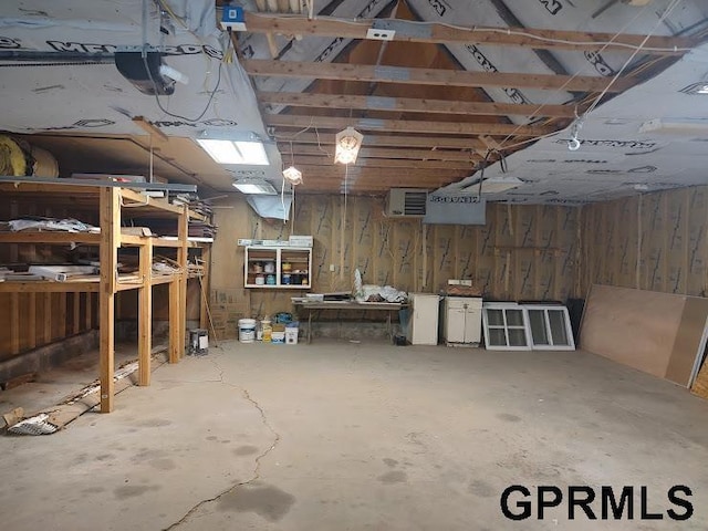 basement featuring a workshop area and wood walls