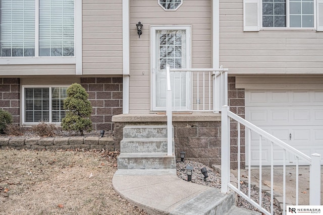 doorway to property featuring a garage