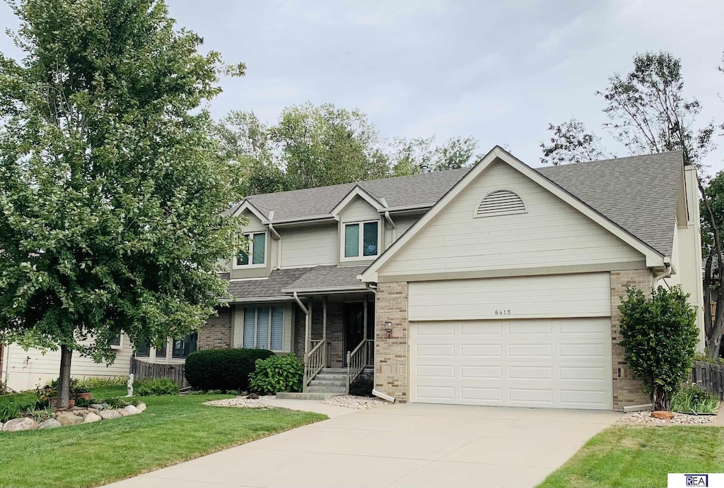 craftsman-style house with a front yard and a garage