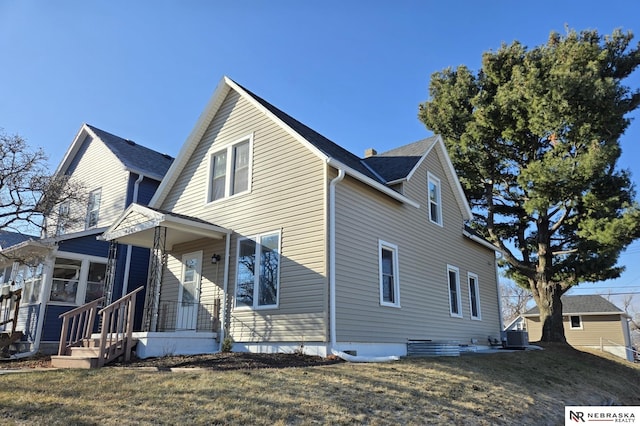 exterior space with central air condition unit and a lawn