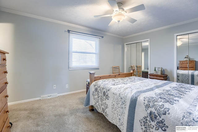 carpeted bedroom featuring ceiling fan, a textured ceiling, and ornamental molding