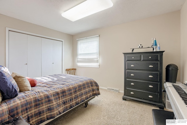 bedroom with carpet floors and a closet