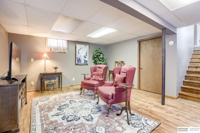 sitting room featuring a paneled ceiling and light wood-type flooring