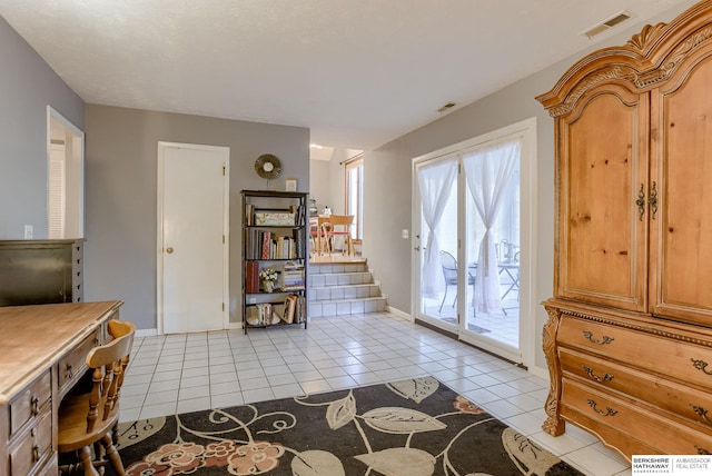 doorway with light tile patterned floors