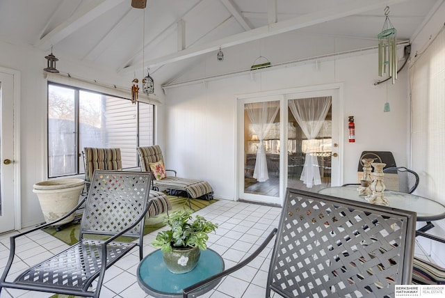 sunroom / solarium featuring vaulted ceiling with beams