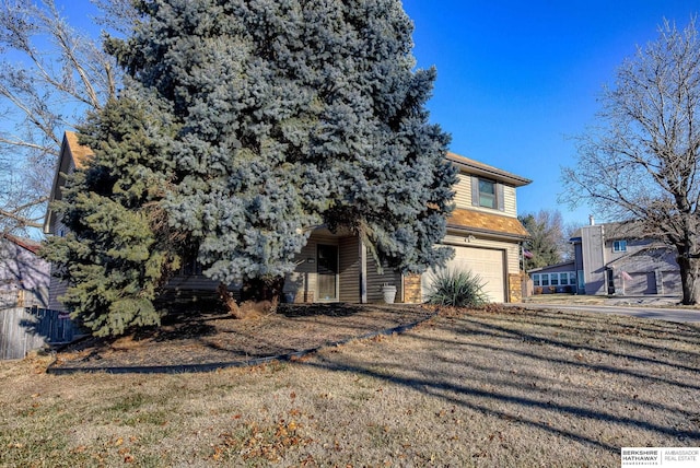 exterior space featuring a garage and a front lawn