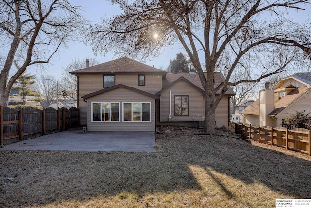 rear view of house featuring a yard and a patio