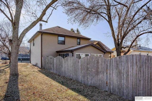 view of side of home with a yard