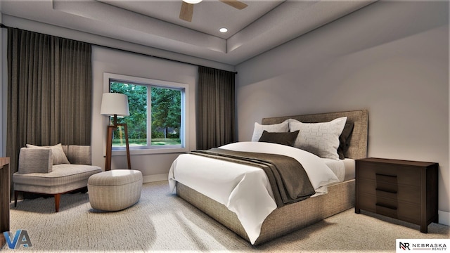 carpeted bedroom with ceiling fan and a tray ceiling