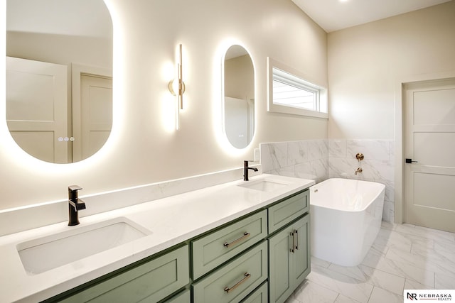 bathroom with tile walls, a bath, and vanity