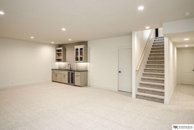 basement featuring wet bar, light colored carpet, and wine cooler